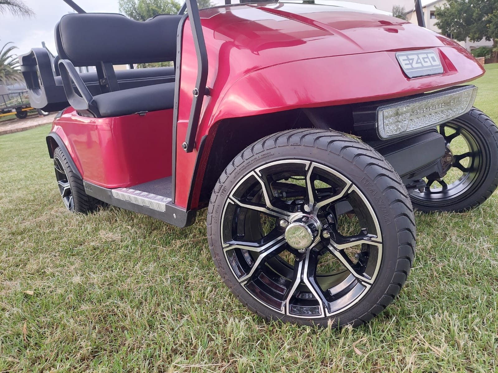 Close-up of a golf cart wheel and battery bay serviced by Golf Car Battery Suppliers